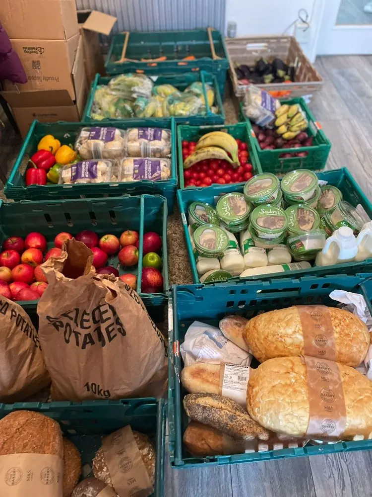 Crates of fresh bread, fruit and vegetables ready to be shared